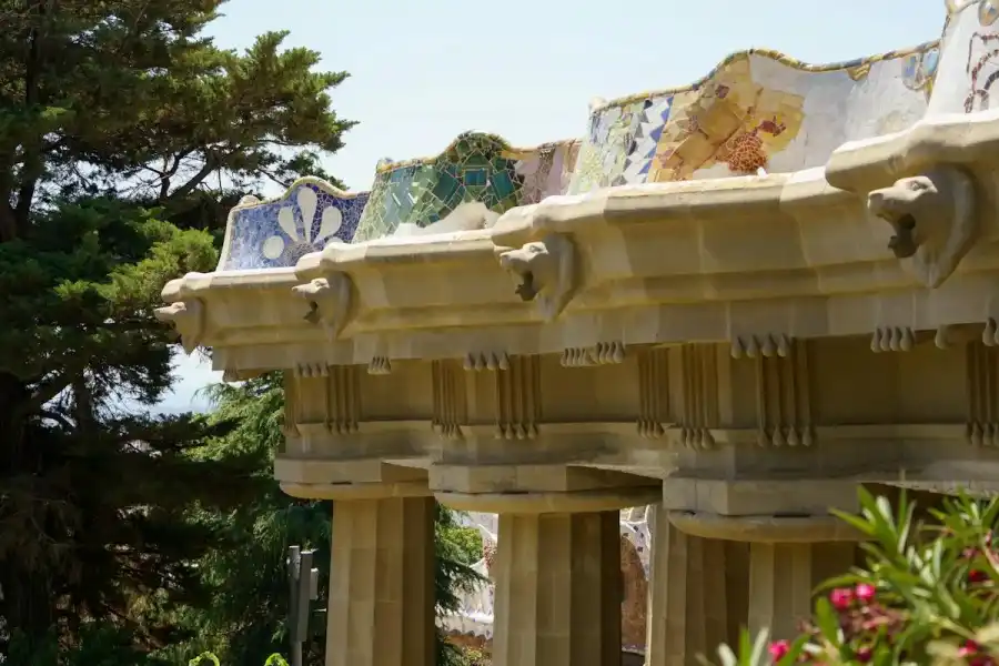 Colourful mosaics at Park Güell with Barcelona skyline
