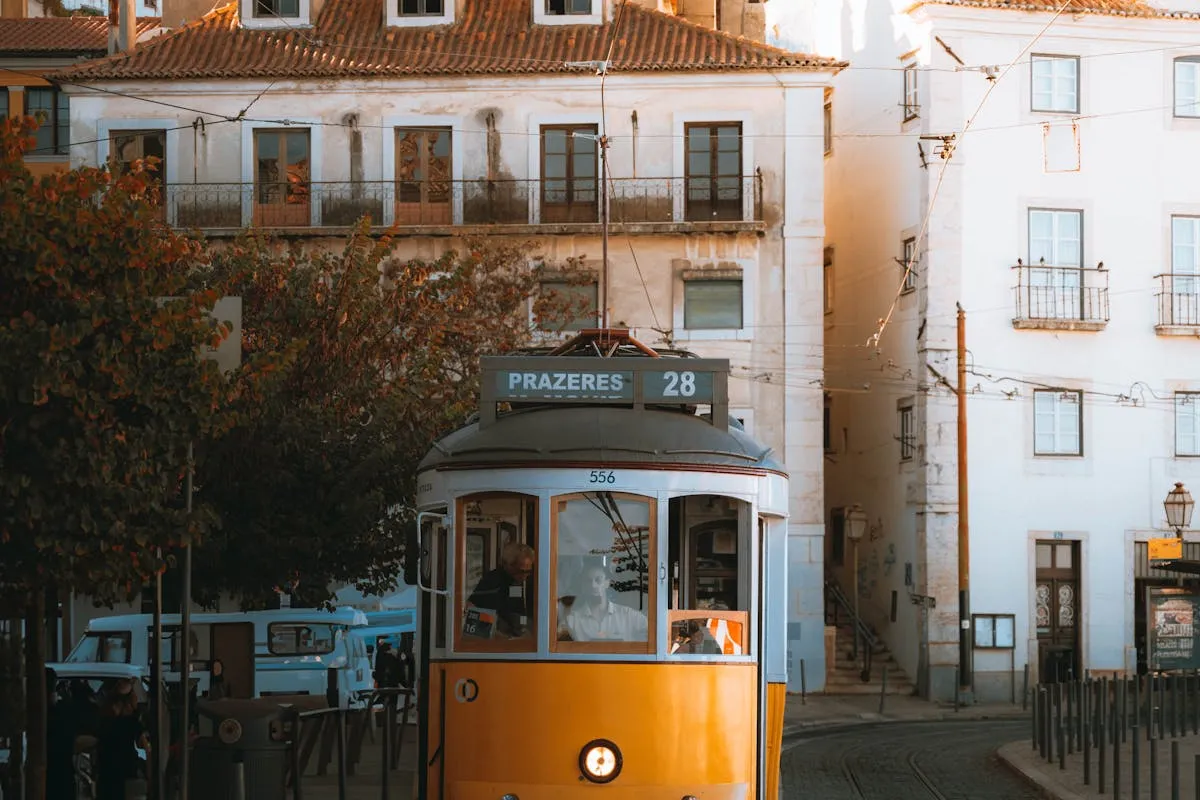 Yellow Tram 28 rattling through the narrow alleys of Alfama in Lisbon