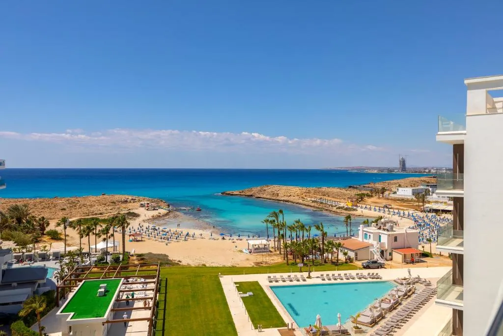 Chrysomare Beach Hotel & Resort aerial view with beach and pools, Ayia Napa