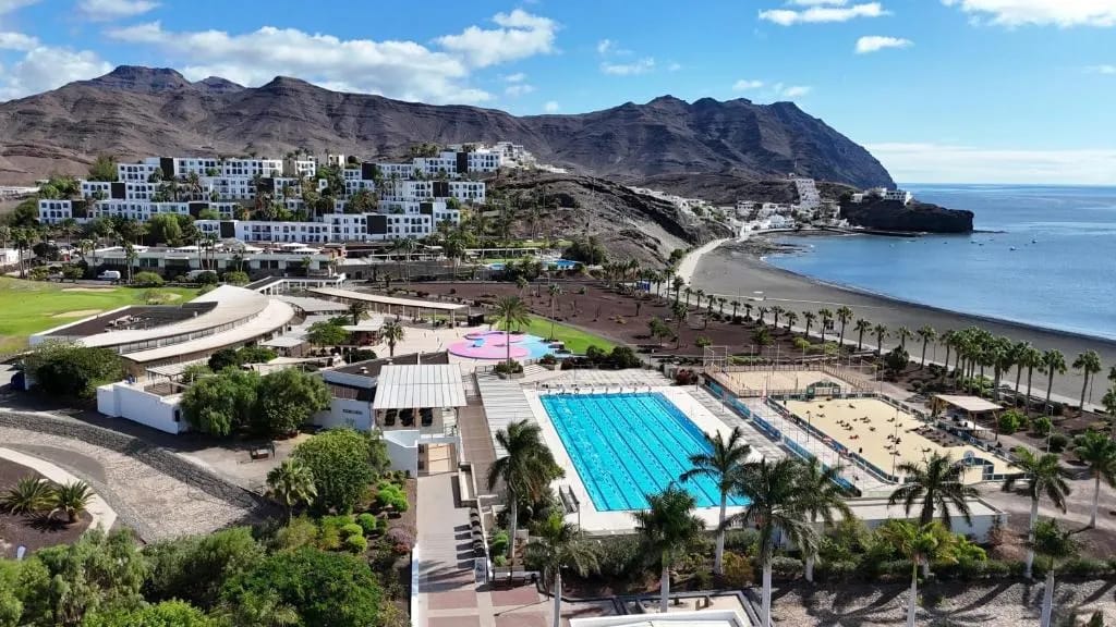 Playitas Resort pool area with palms and sun loungers, Fuerteventura