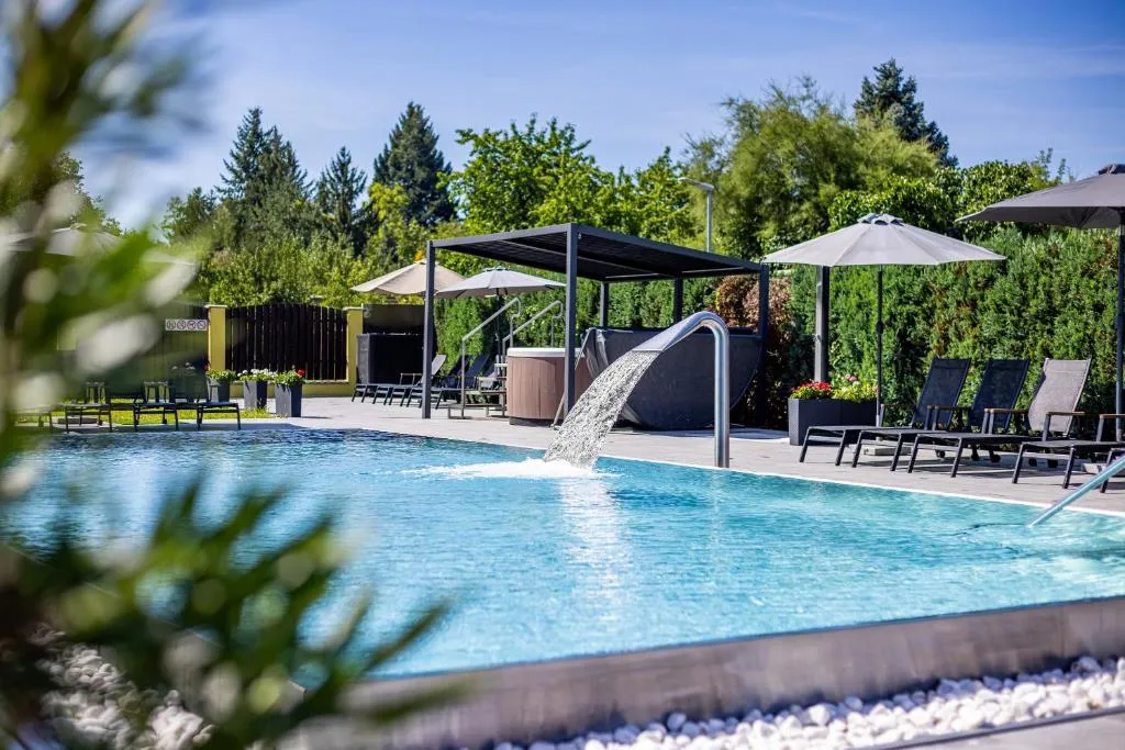 Hotel Aura Design exterior with garden pool area in Prague