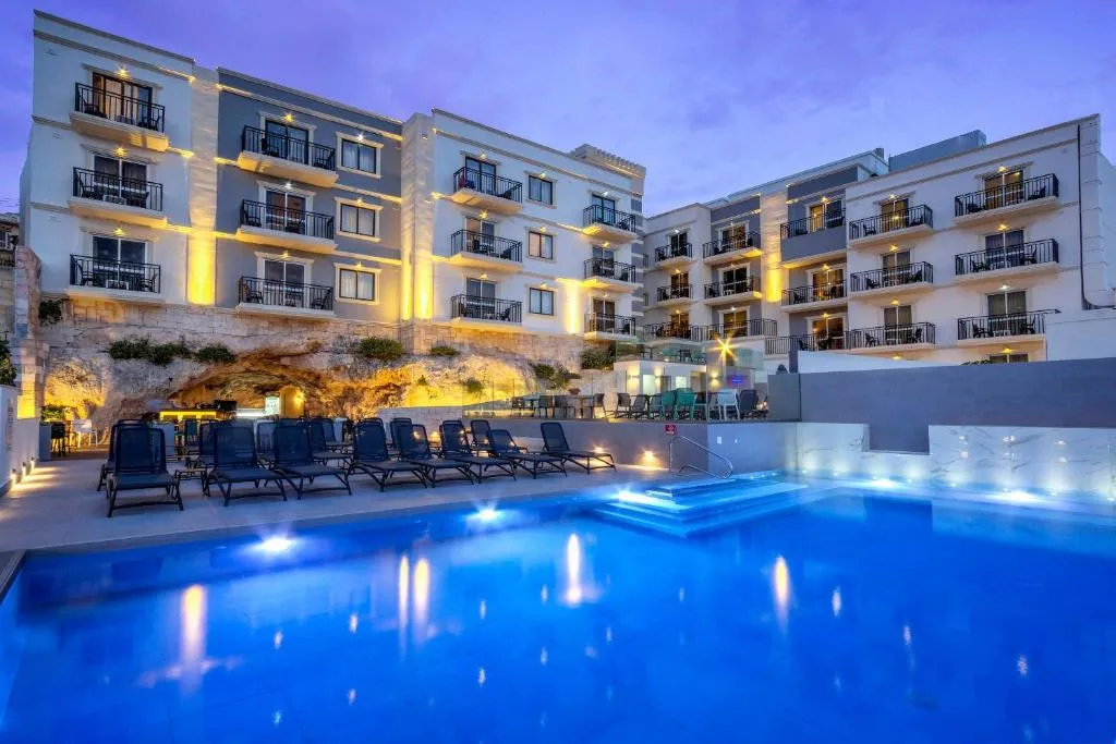 Outdoor pool with view of Mellieha Bay at Pergola Hotel & Spa, Malta