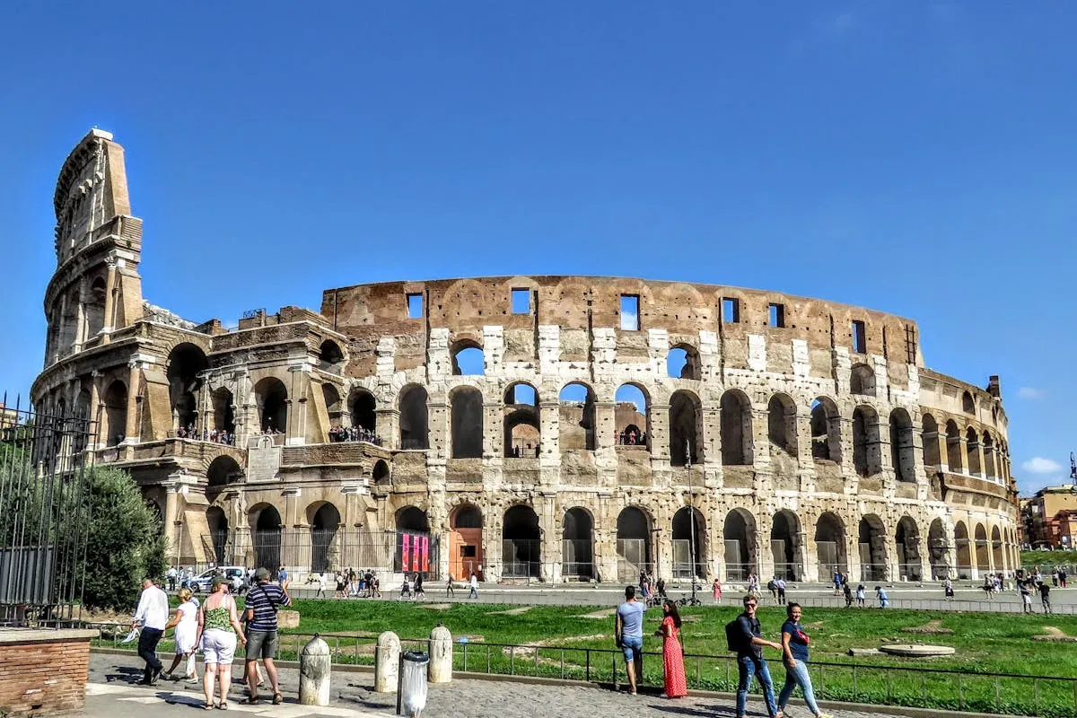 Tourists visiting the Colosseum in Rome under summer sun